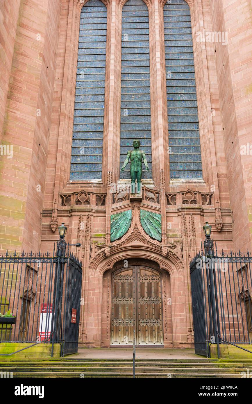 The Welcoming Christ, a large bronze sculpture by Dame Elisabeth Frink, was installed over the outside of the west door of the cathedral.Liverpool Cat Stock Photo