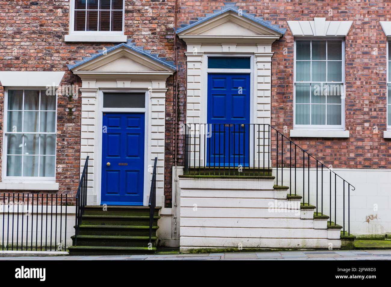 Two blue wooden front doors at the entrance of townhouses. Liverpool