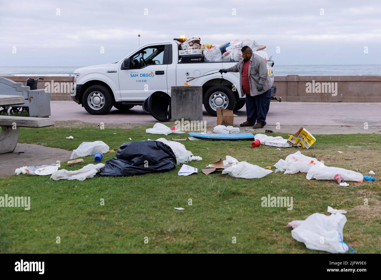 Cleanup begins following the Fourth of July holiday as a city worker picks up trash left behind at Pacific Beach in San Diego, California, U.S. July 5, 2022. REUTERS/Mike Blake Stock Photo