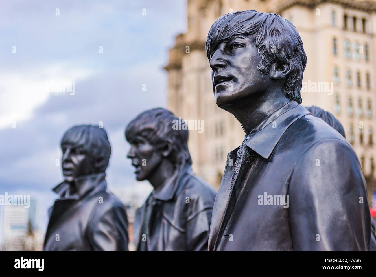 John Lennon, detail. The Beatles statue in their home city Liverpool, at Pier Head on Liverpool waterfront. Leverpool, Merseyside, Lancashire, England Stock Photo