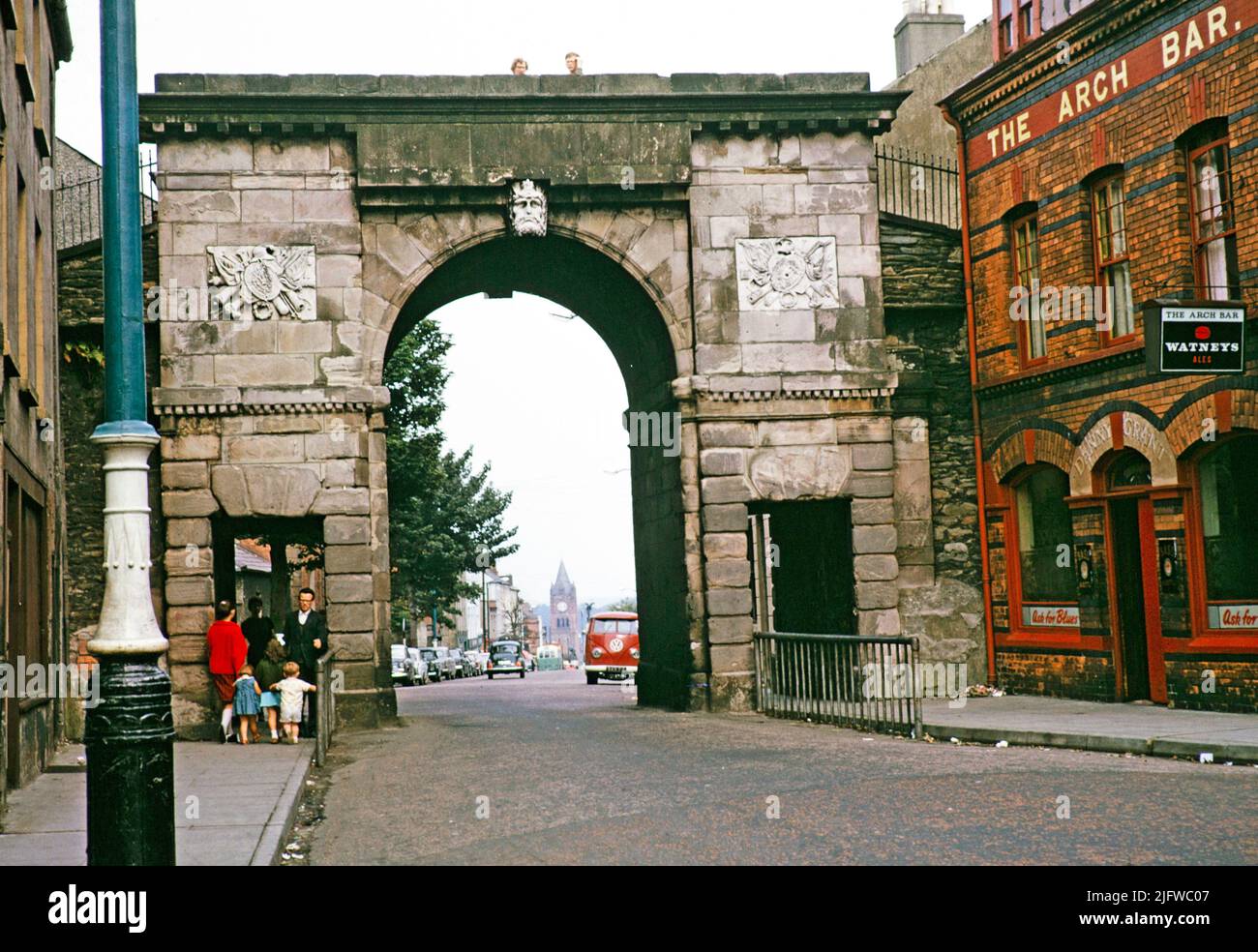 Bishop's Gate part of the old city walls built 1789, and The Arch Bar pub, Derry Londonderry, Northern Ireland, UK 1960s Stock Photo