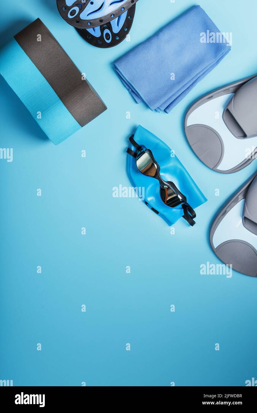 Sports equipment for swimming in the pool and open water on a blue background, close-up Stock Photo