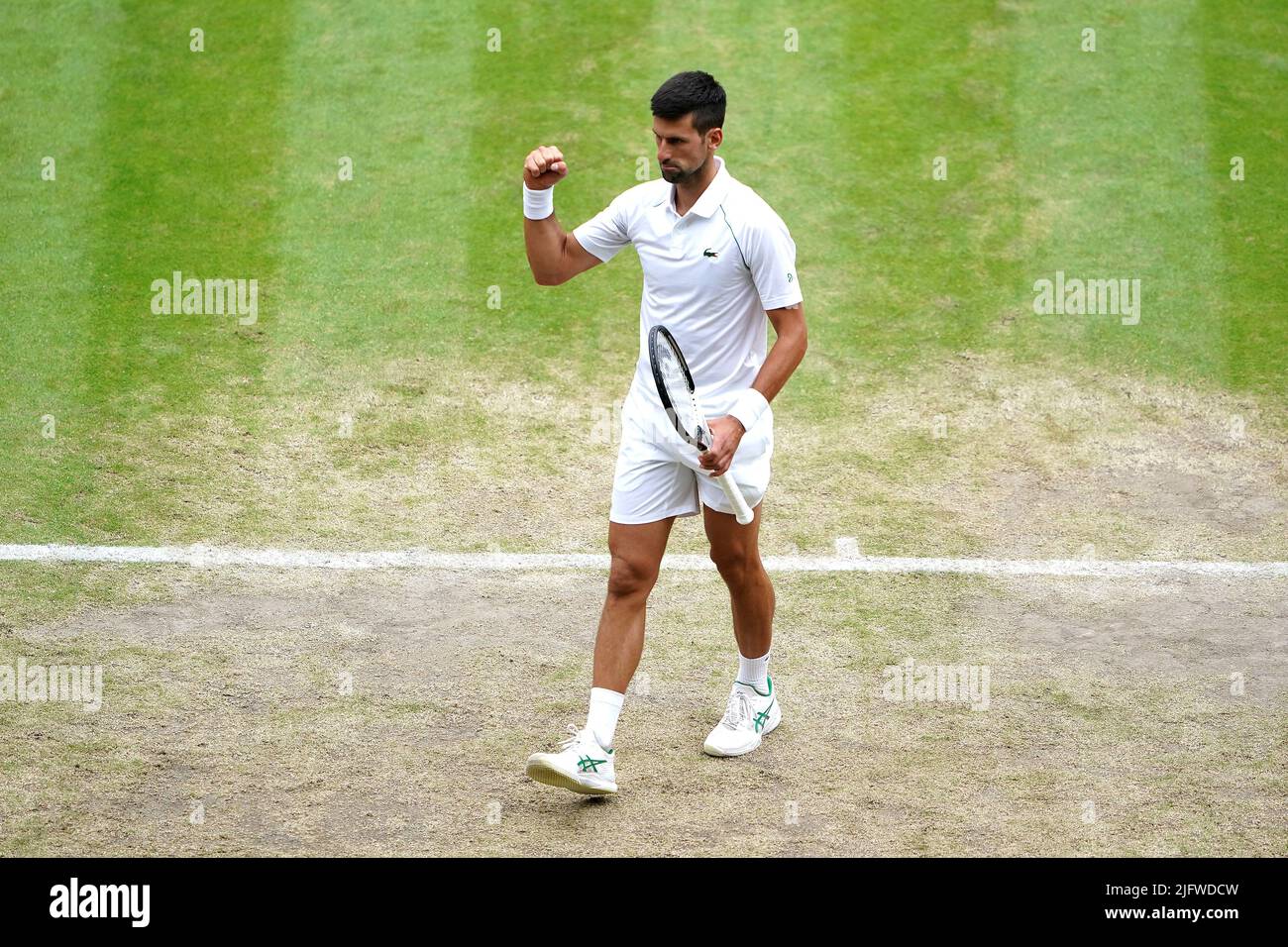 Serbia's Novak Djokovic celebrates victory against Italy's Jannik Sinner in the quarter finals match on day nine of the 2022 Wimbledon Championships at the All England Lawn Tennis and Croquet Club, Wimbledon. Picture date: Tuesday July 5, 2022. Stock Photo