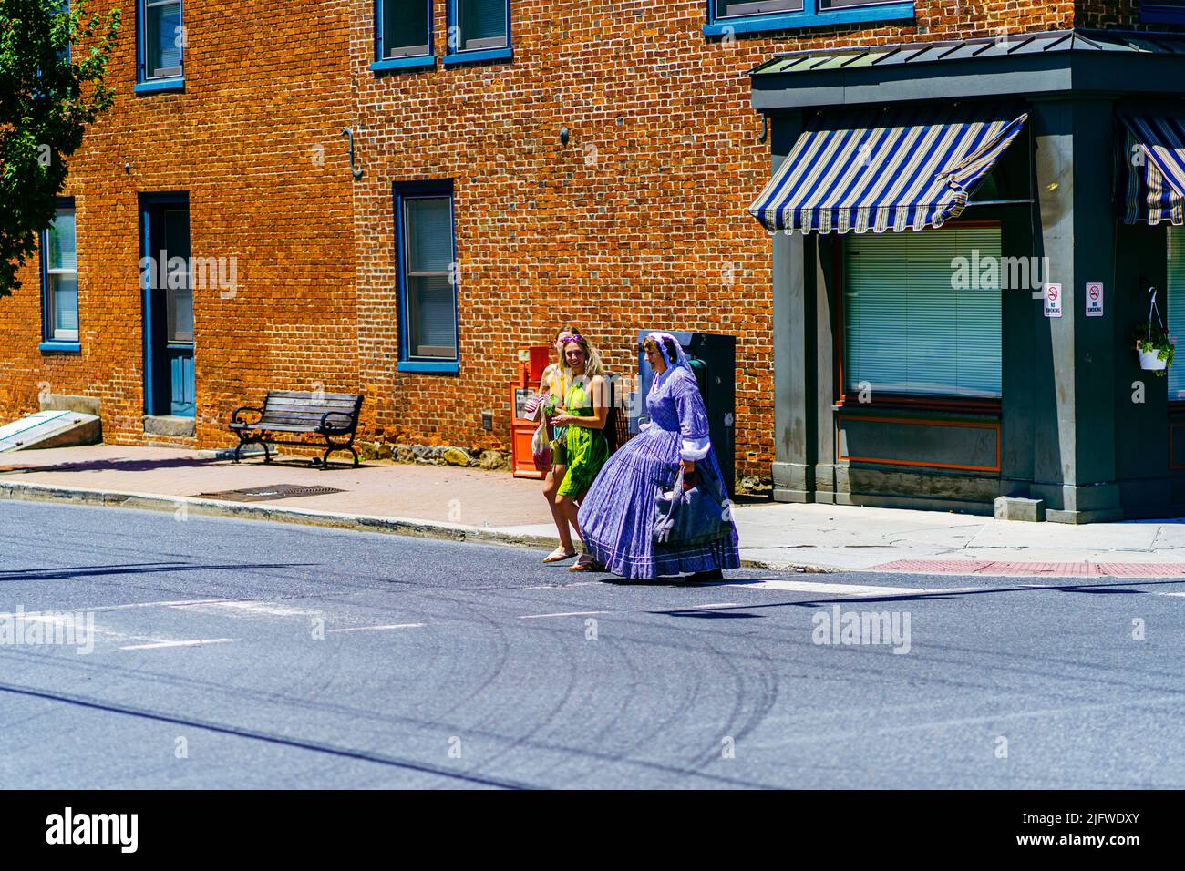 Gettysburg, PA, USA – July 3, 2022: A Civil War era reenactor walks on street in the historic town of Gettysburg wearing period over the July 4th cele Stock Photo