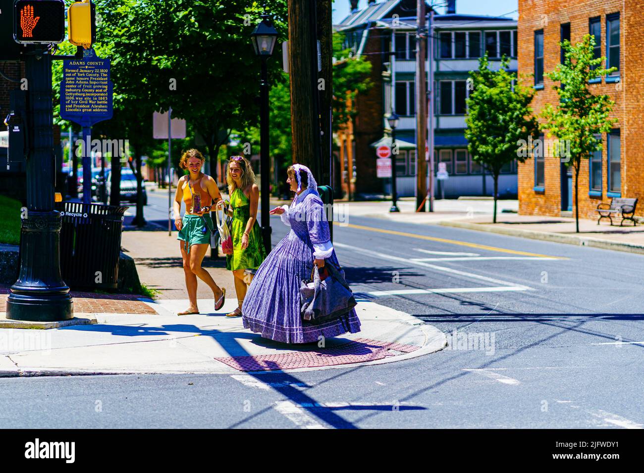 Gettysburg, PA, USA – July 3, 2022: A Civil War era reenactor walks on street in the historic town of Gettysburg wearing period over the July 4th cele Stock Photo