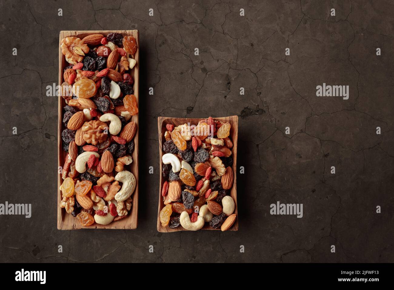 The mix of dried fruits and berries on a stone background. Presented