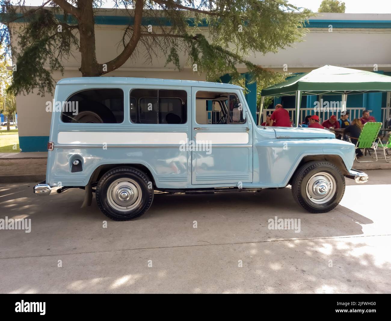 Old light blue jeep IKA Estanciera ex Overland Willys station wagon circa 1960 parked in the street. Side view. Classic car show. Copyspace Stock Photo