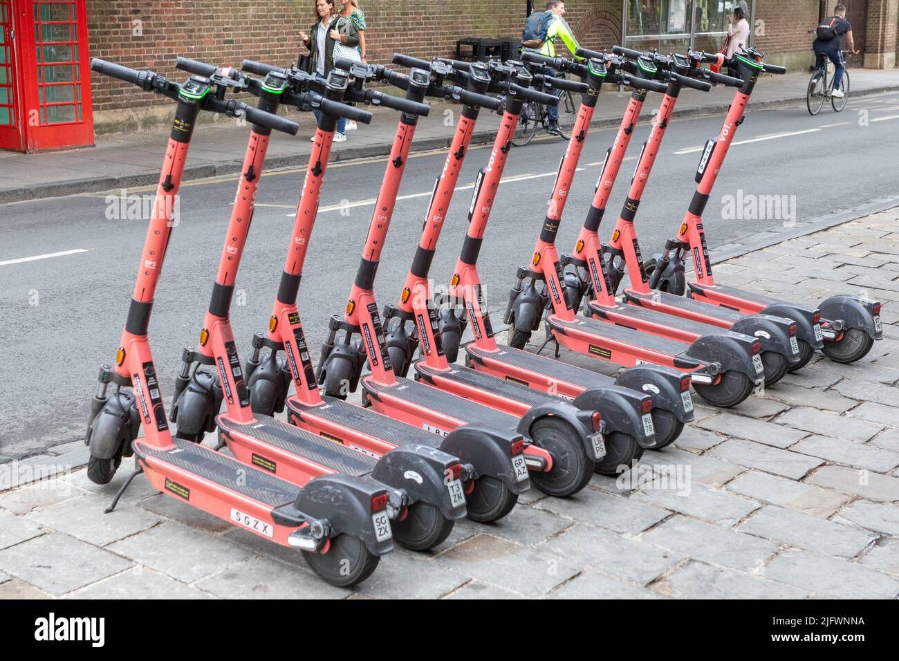 Electric scooters packed in a row on a pavement in Cambridge, UK.   Image shot on 29th June 2022.  © Belinda Jiao   jiao.bilin@gmail.com 07598931257 h Stock Photo