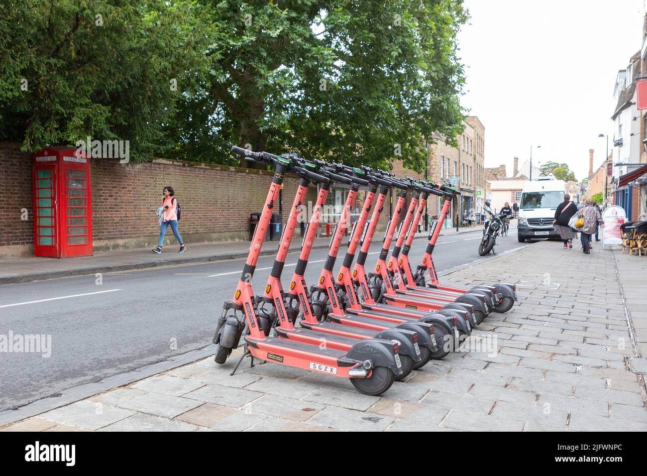 Electric scooters packed in a row on a pavement in Cambridge, UK.   Image shot on 29th June 2022.  © Belinda Jiao   jiao.bilin@gmail.com 07598931257 h Stock Photo