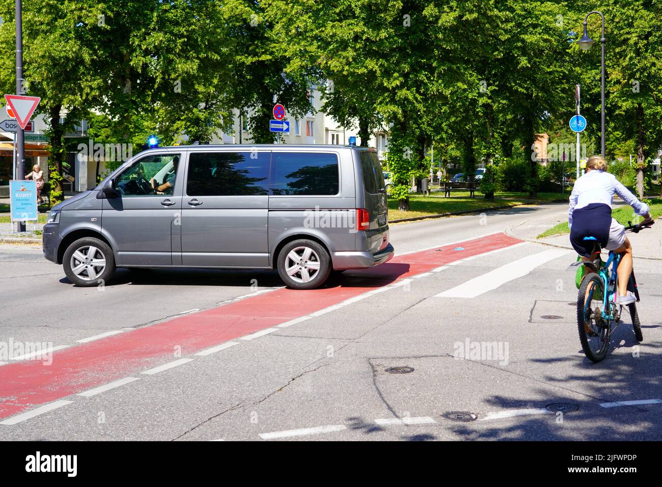 A German Criminal Police vehicle on a mission trip crosses a road intersection. Stock Photo