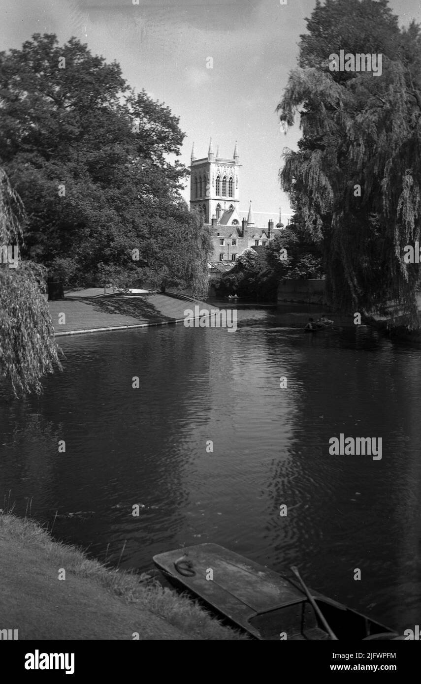 1950s, historical, St Johns Tower, the chapel tower of St John's College, Cambridge University, England, UK. An iconic landmark of Cambridge at 160 feet high, it was designed by famous British architect Sir George Gilbert Scott. Punt moored on the river Cam. Stock Photo