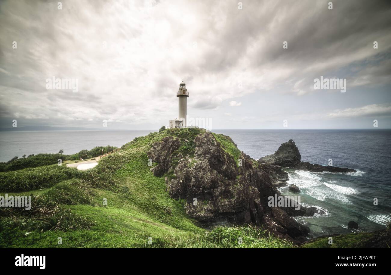 A beautiful landscape of the lighthouse on a cloudy day in Oganzaki, Sakieda, Ishigaki, Okinawa, Japan Stock Photo