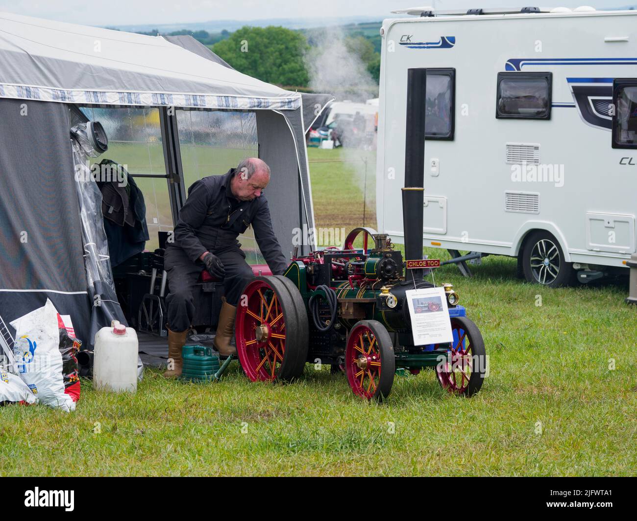 Man displaying his 4 inch scale model Foster Agricultural traction engine at the Launceston Steam & Vintage Rally, Cornwall, UK Stock Photo