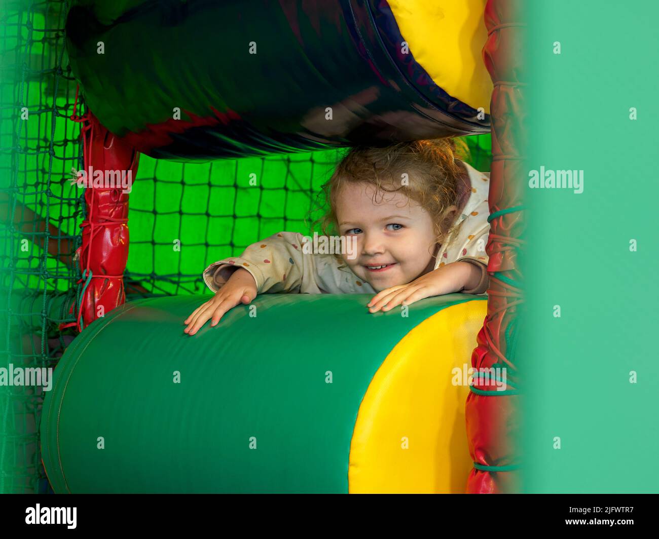Young child playing in a soft play, UK Stock Photo