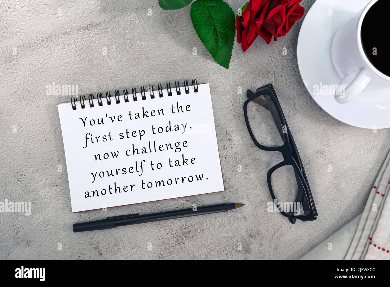 Motivational quote on notebook on white marble table You've taken the