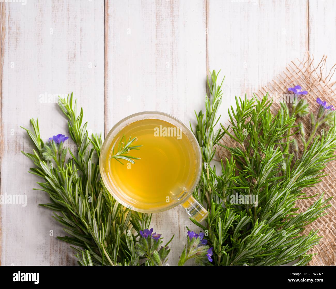 Rosemary tea on wooden table. Herbal teas concept. ( Salvia rosmarinus tea ) Stock Photo