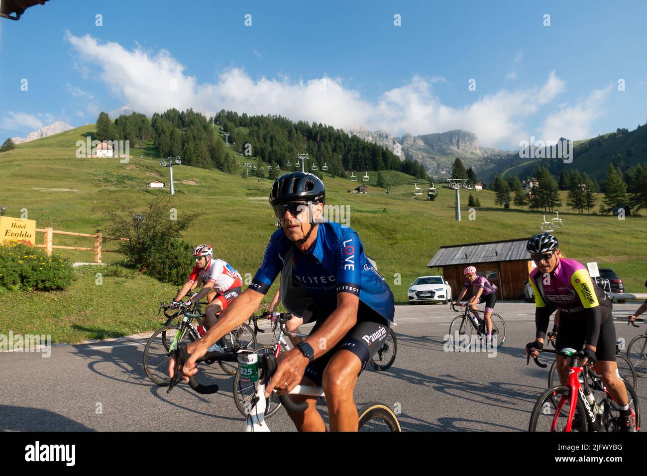 Arabba, Italy - July 03th 2022:  Road bike marathon at the Dolomites, Italy.  Participants crossing the village Arabba Stock Photo