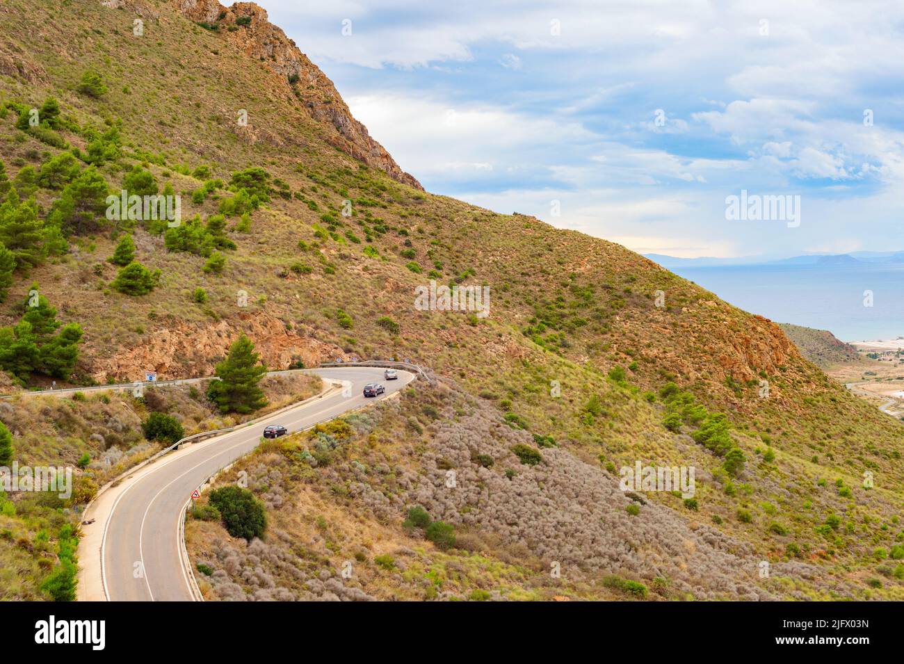 Aerial view of cars on road curve, mountains landscape, Spain Stock Photo