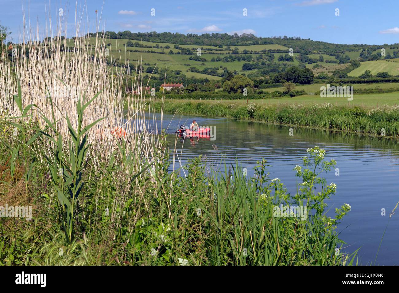 Boating on the river Avon, Saltford near Bristol, with rolling hills in