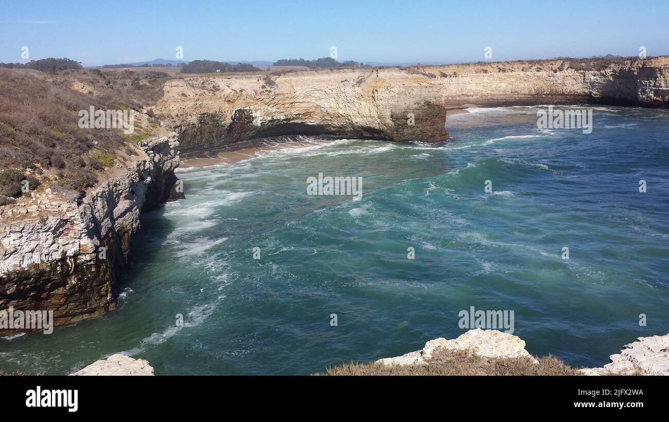 Bonny Doon beach, Santa Cruz, California. USGS cliff surveying (GPS for top and toe of the cliff and terrestrial lidar scan). The data and information collected is vital to understanding cliff erosion and landslides within the area. Credit: M.Palaseanu-Lovejoy, USGS. Stock Photo