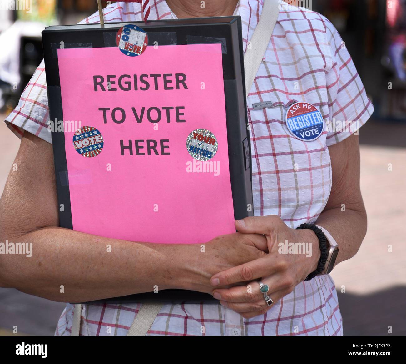 A volunteer at a Fourth of July holiday event in Santa Fe, New Mexico, registers citizens to vote in upcoming U.S. elections. Stock Photo