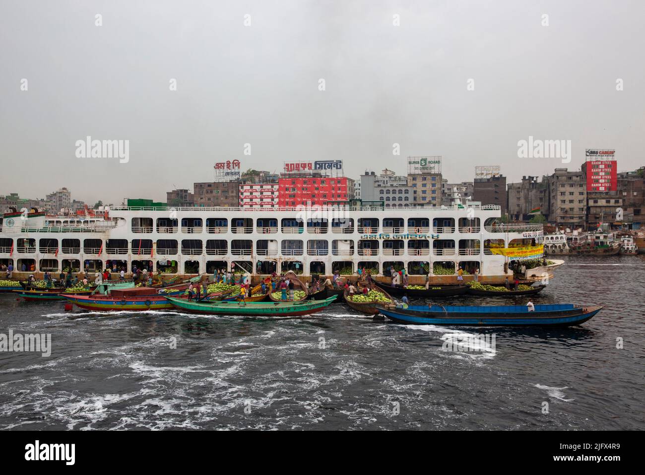Watermelon unloaded from big vessel to small boat on the Buriganga River in Old Dhaka, Bangladesh Stock Photo