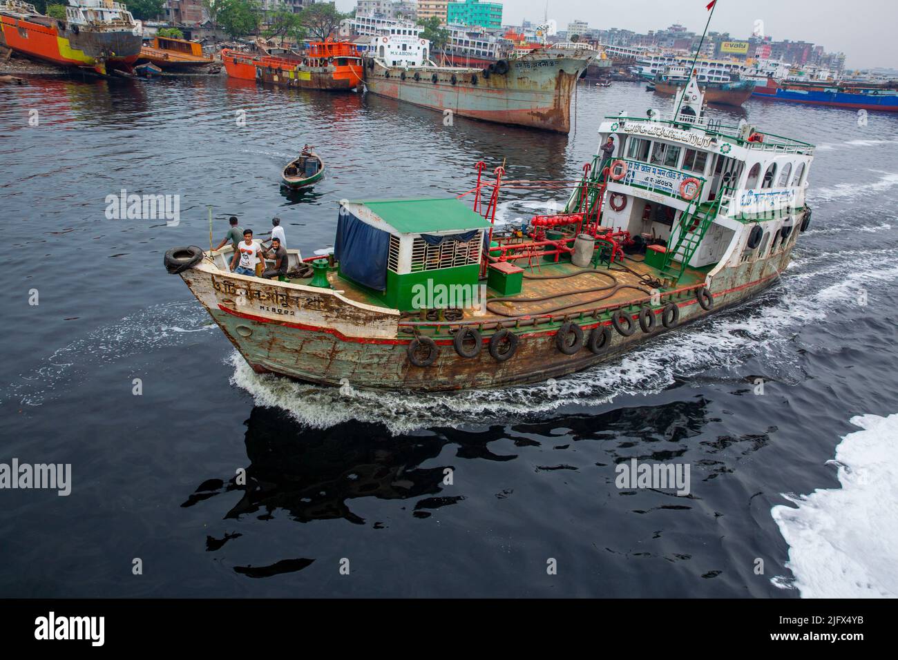 A small oil tanker on the polluted water of Buriganga River, Dhaka, Bangladesh Stock Photo