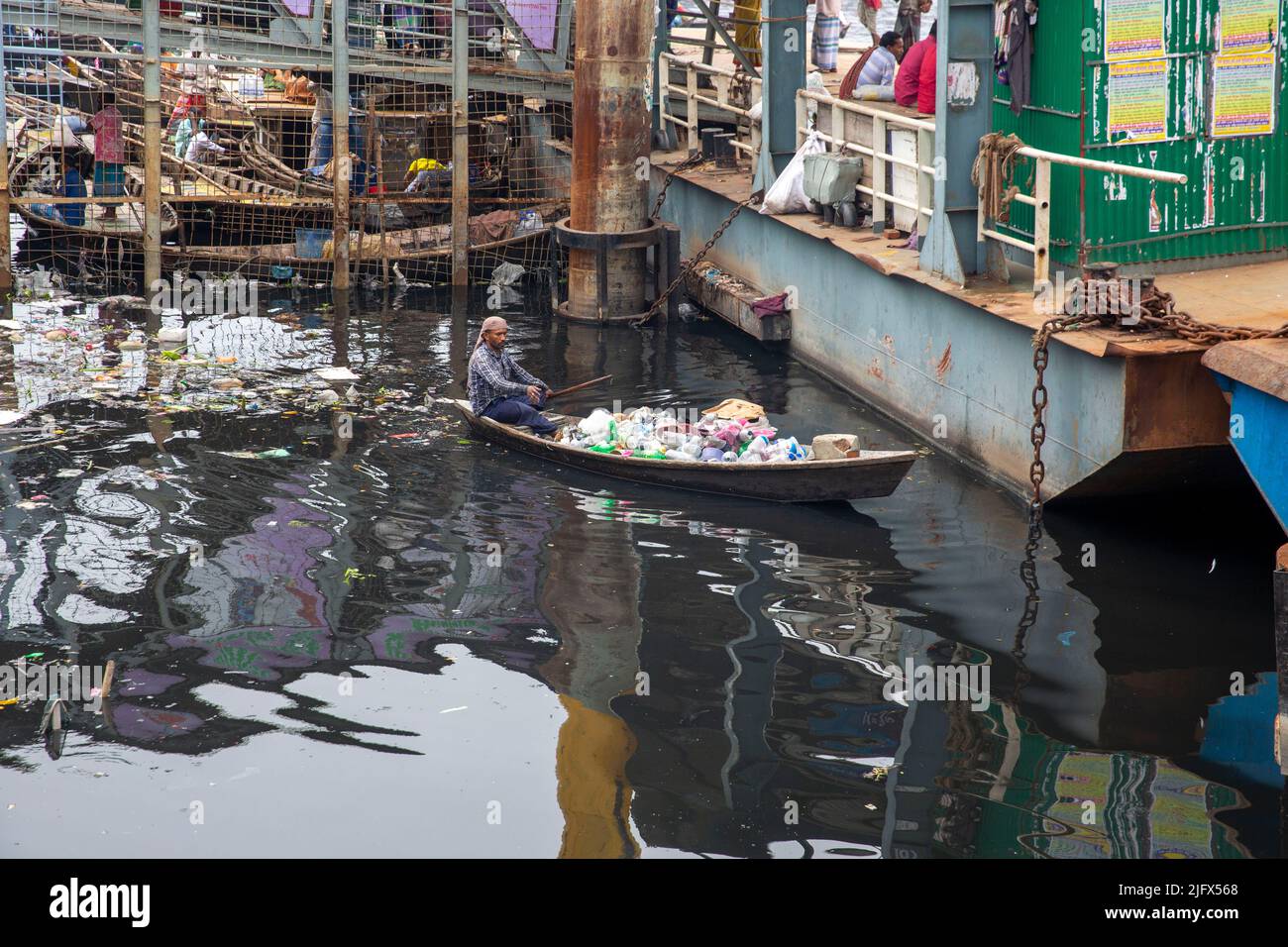 A man collects plastic waste form Buriganga River, Dhaka, Bangladesh Stock Photo