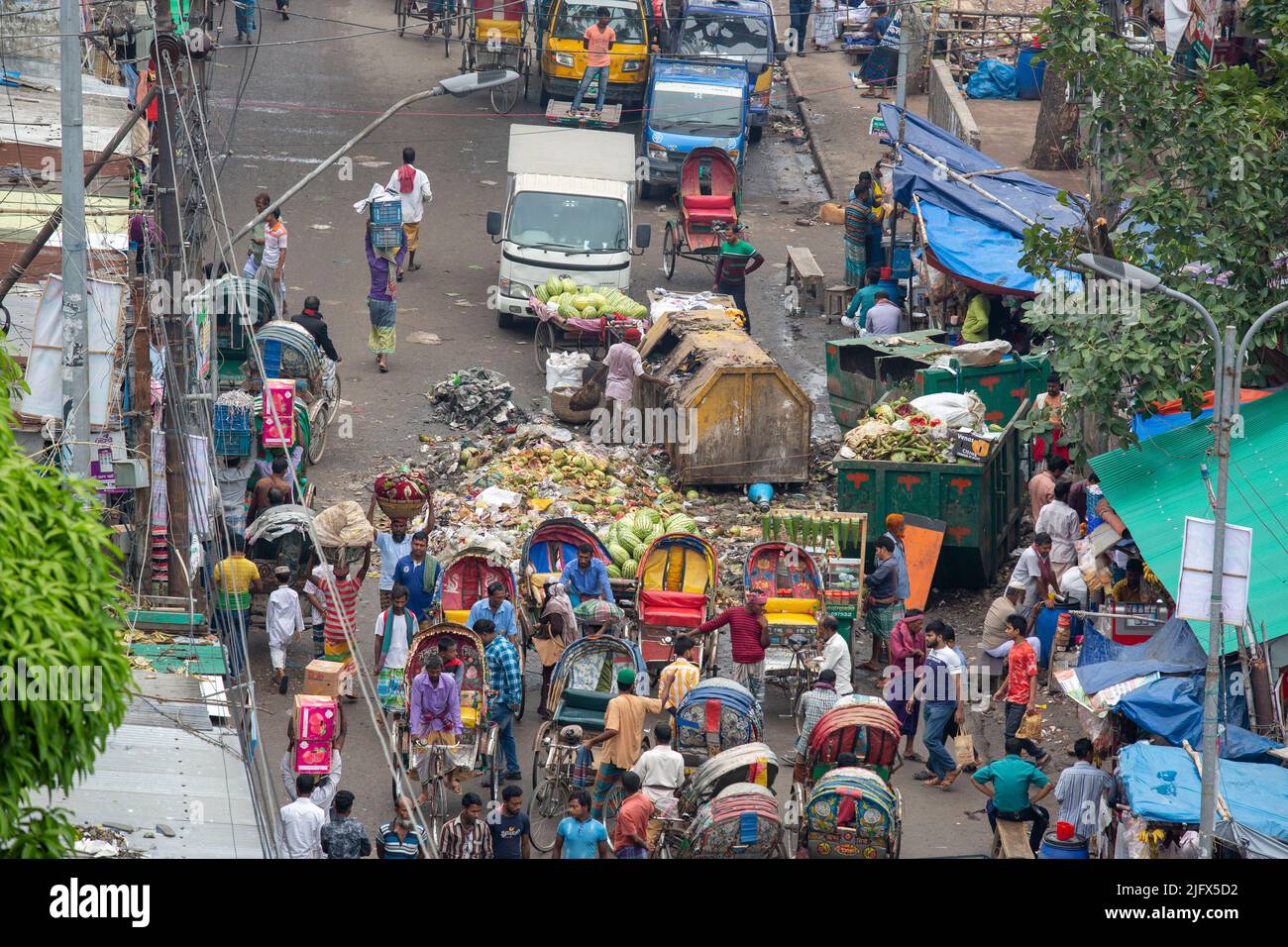 Waste bins in the middle of a busy road at old Dhaka, Bangladesh Stock Photo