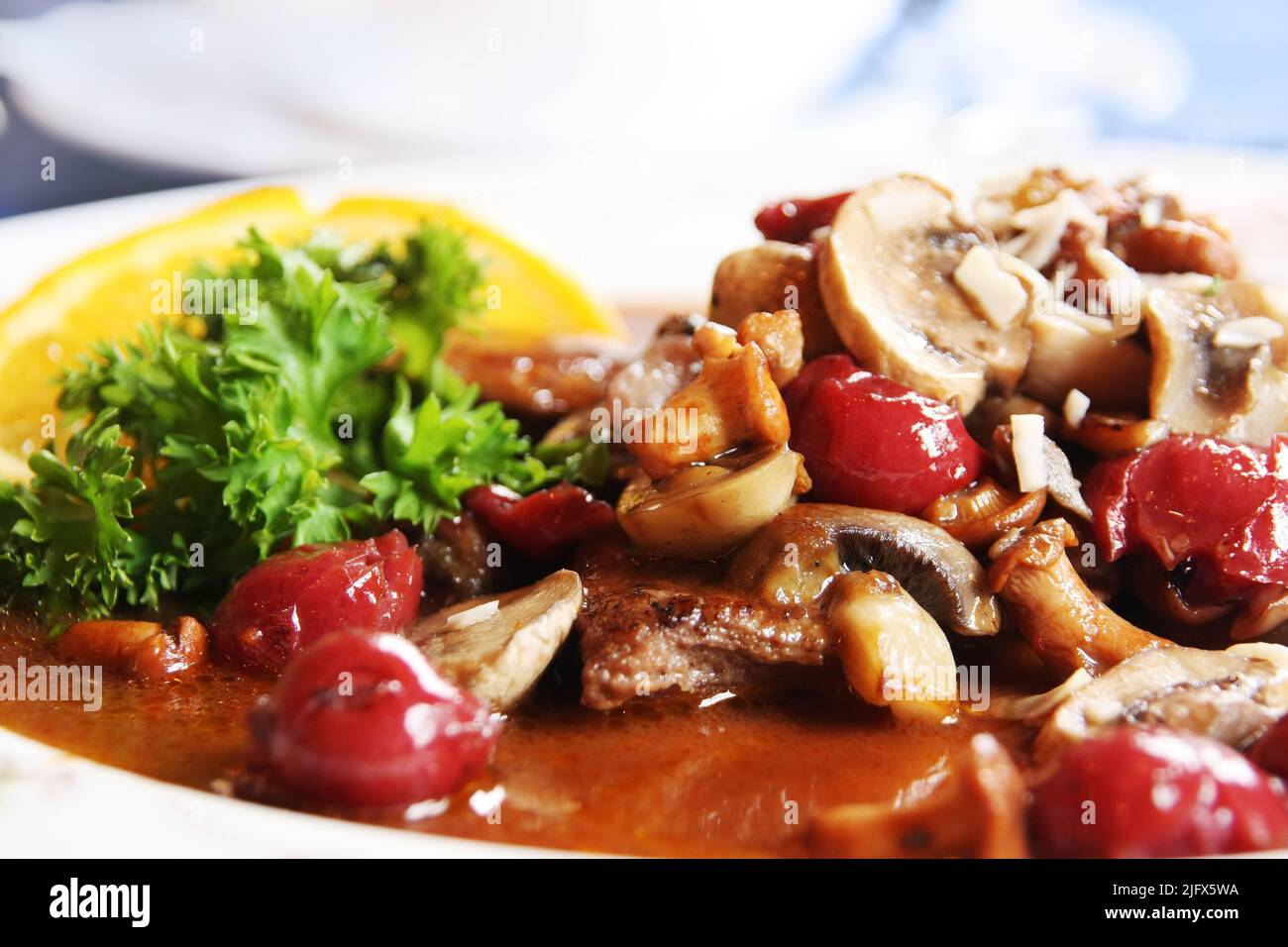 German food specialty: boar stew with mushroom and cherry Stock Photo