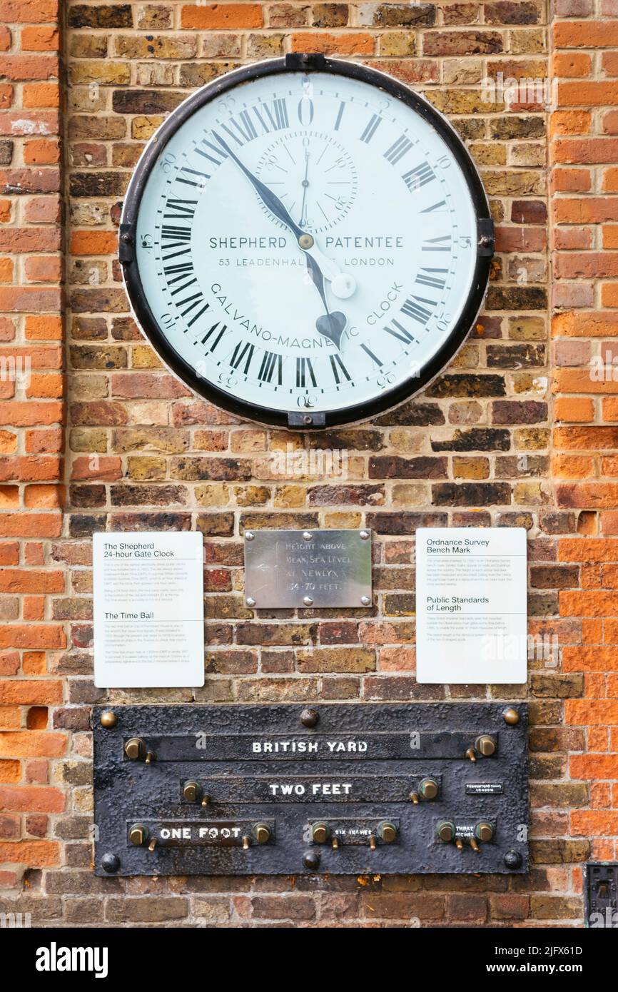 The Shepherd Gate Clock is mounted on the wall outside the gate of the Royal Observatory. The clock, an early example of an electric clock, was a slav Stock Photo