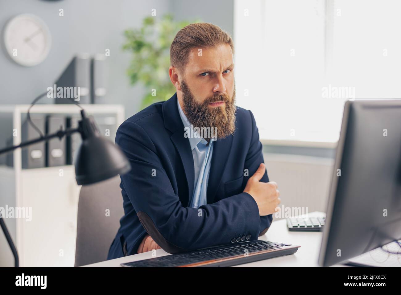 Pensive man working in office Stock Photo