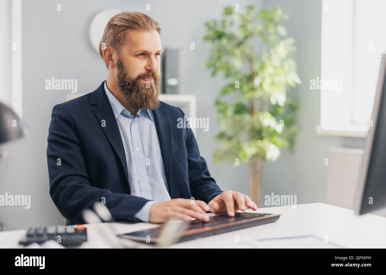 Successful businessman working on pc Stock Photo