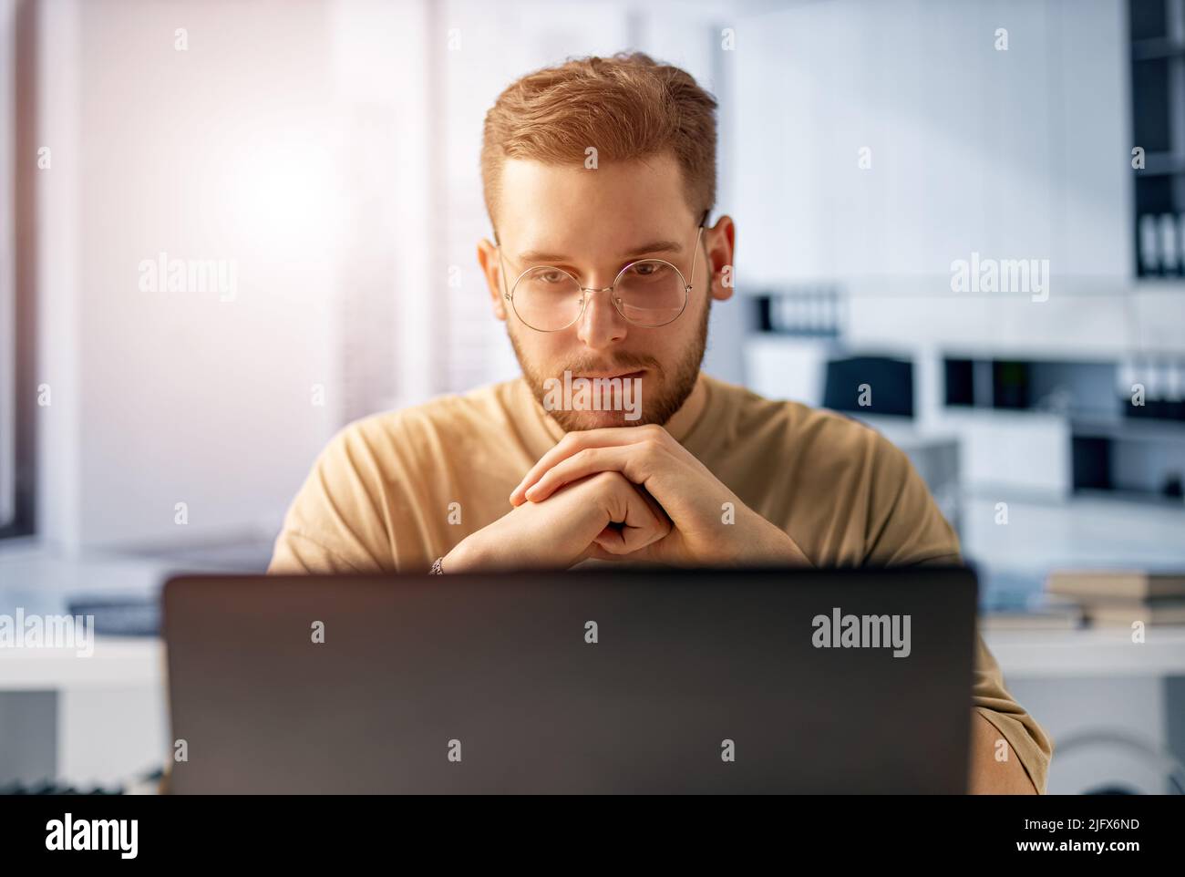 Man using laptop in office Stock Photo