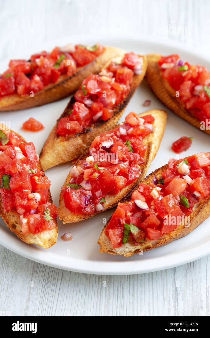 Homemade Italian Tomato Bruschetta with Basil on a Plate, side view