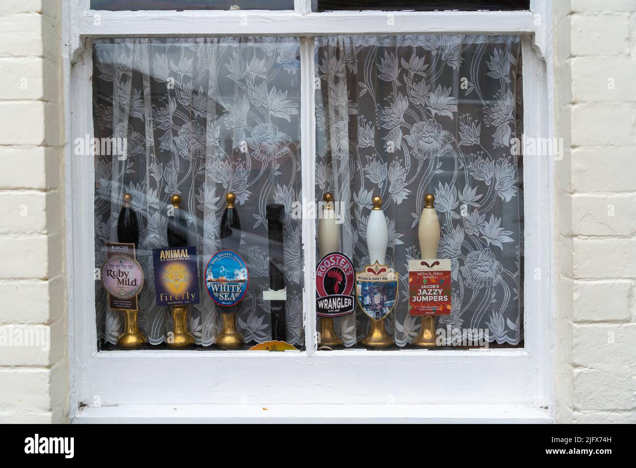 The Strugglers Inn, Lincoln City, pub, front window, old beer pump handles, net curtains, passing trade, proper pub, real ale, beer garden, cask ales. Stock Photo