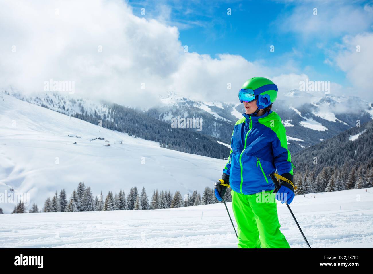 Close portrait of a preteen boy stand on the ski track Stock Photo