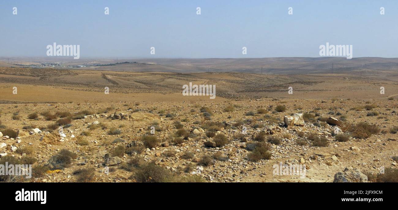 Incredible panorama of the nullity of the desert with a few dry shrubs and very hot rocks in the Middle Eastern areas between Europe and Asia Stock Photo
