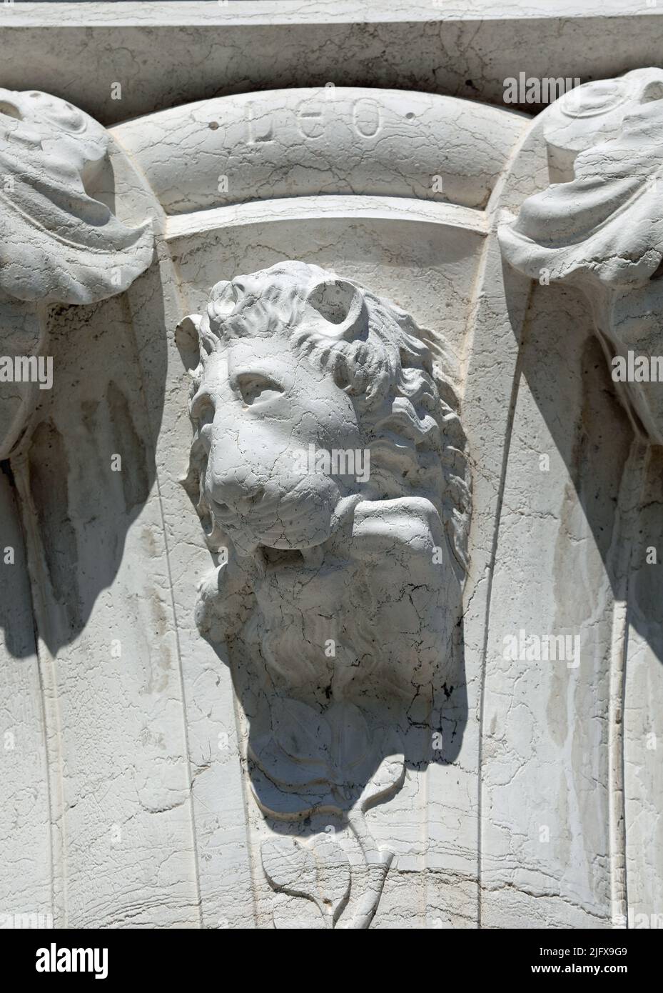 statue of a lion s muzzle with the inscription Leo on the column of the Ancient Italian Palace