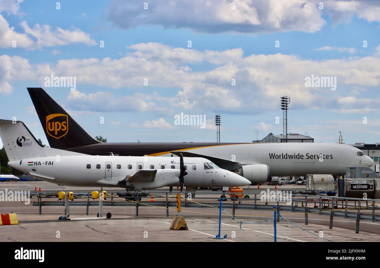 UPS Worldwide Services plane and commuter airplane at Helsinki airport June 16th 2022 Stock Photo