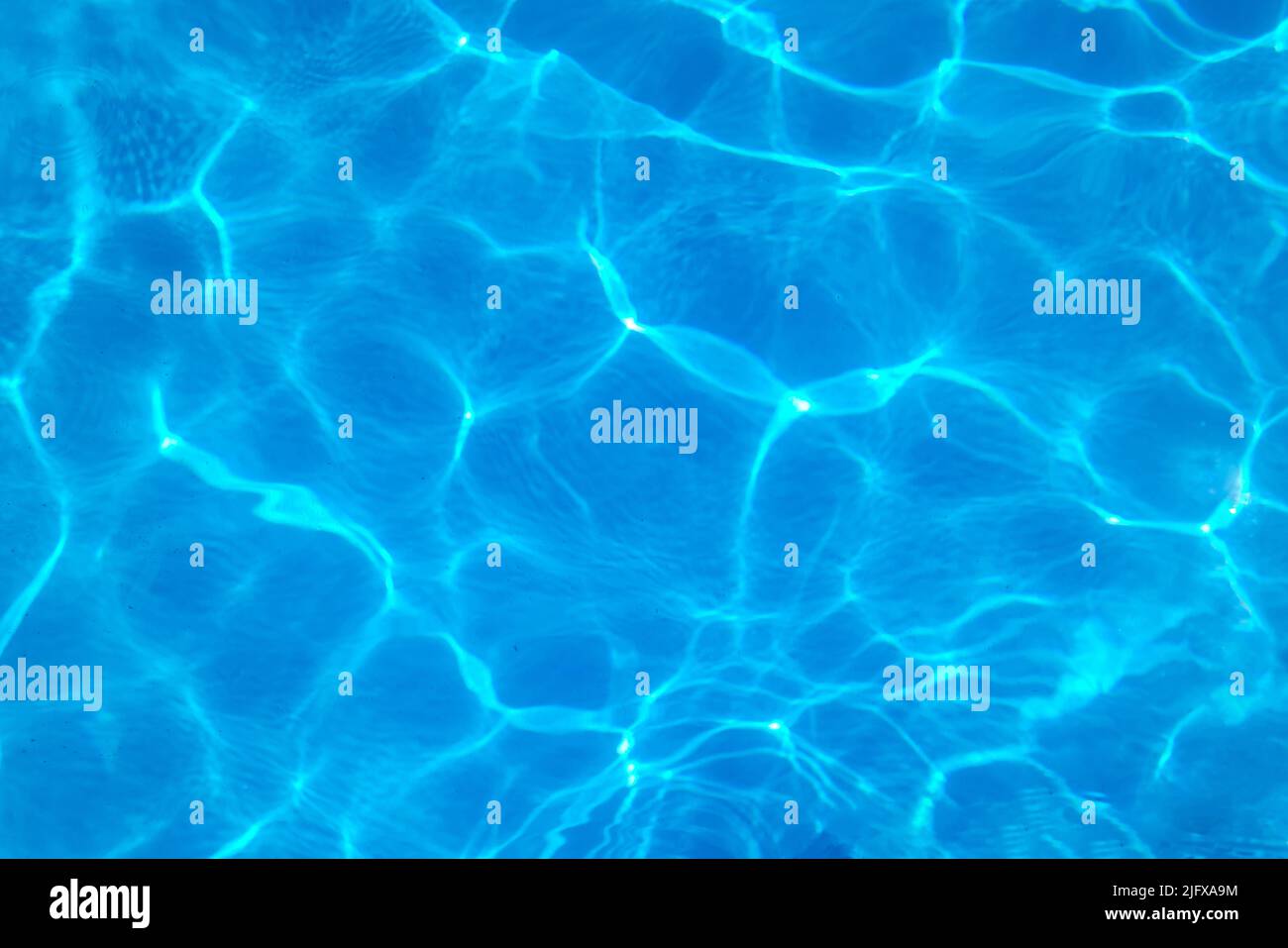 Sunlight creating abstract design on swimming pool water Stock Photo