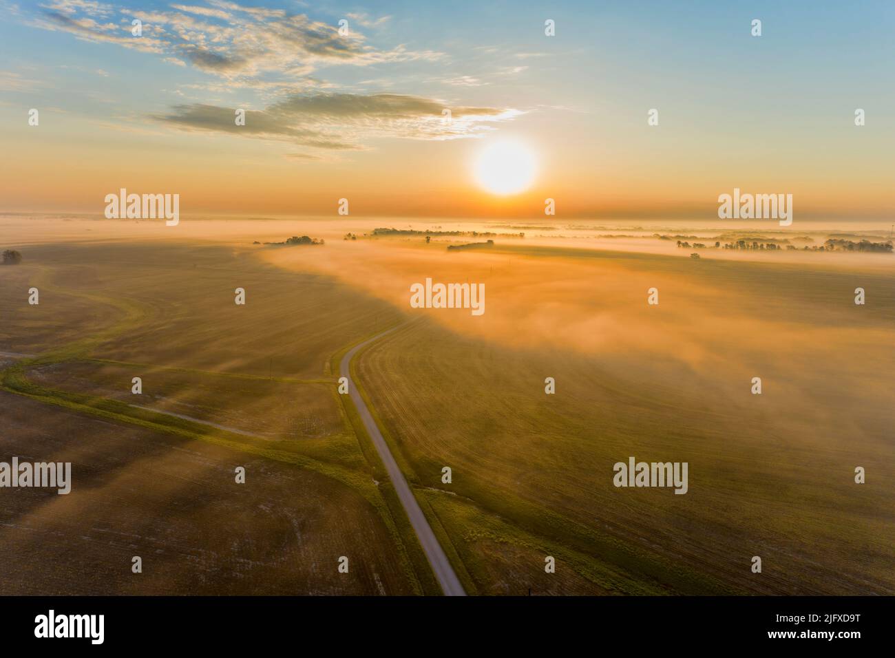 63895-18120 Aerial of country road in fog at sunrise Marion Co. IL Stock Photo