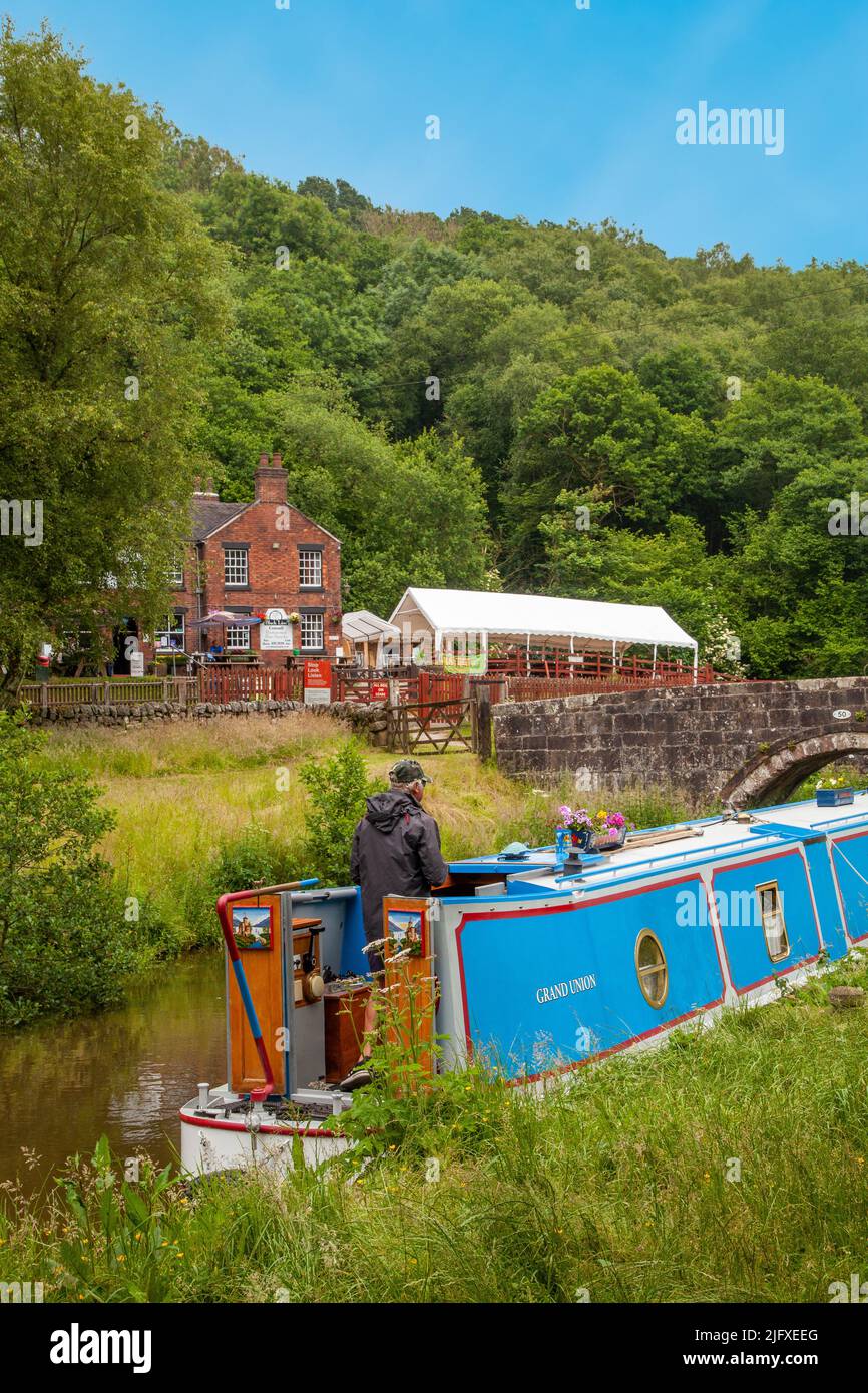 Canal narrowboat moored on the Caldon canal outside the Black Lion pub at Consall Wharf in the Churnet  valley Staffordshire England Stock Photo