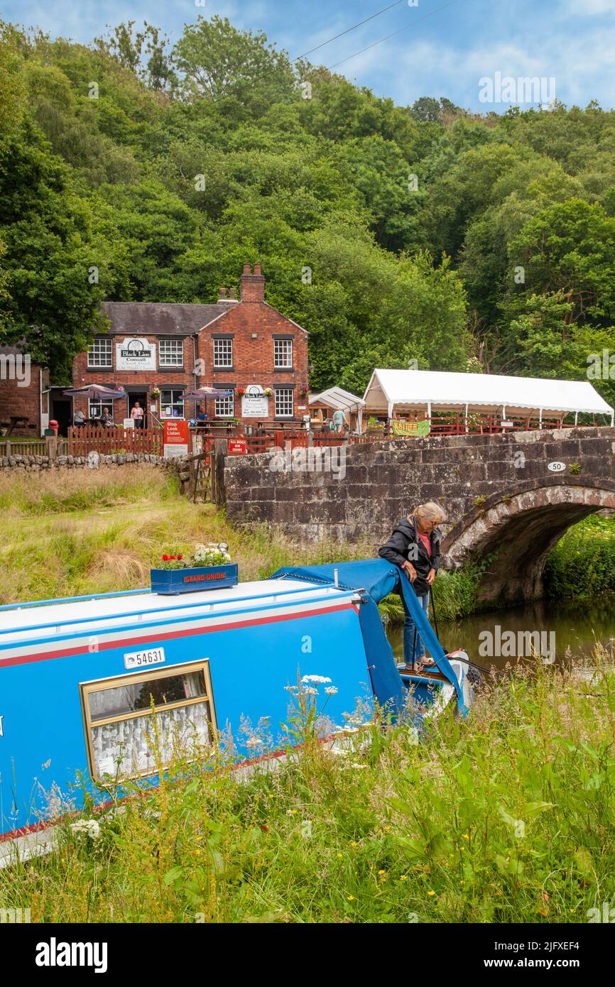 Canal narrowboat moored on the Caldon canal outside the Black Lion pub at Consall Wharf in the Churnet  valley Staffordshire England Stock Photo