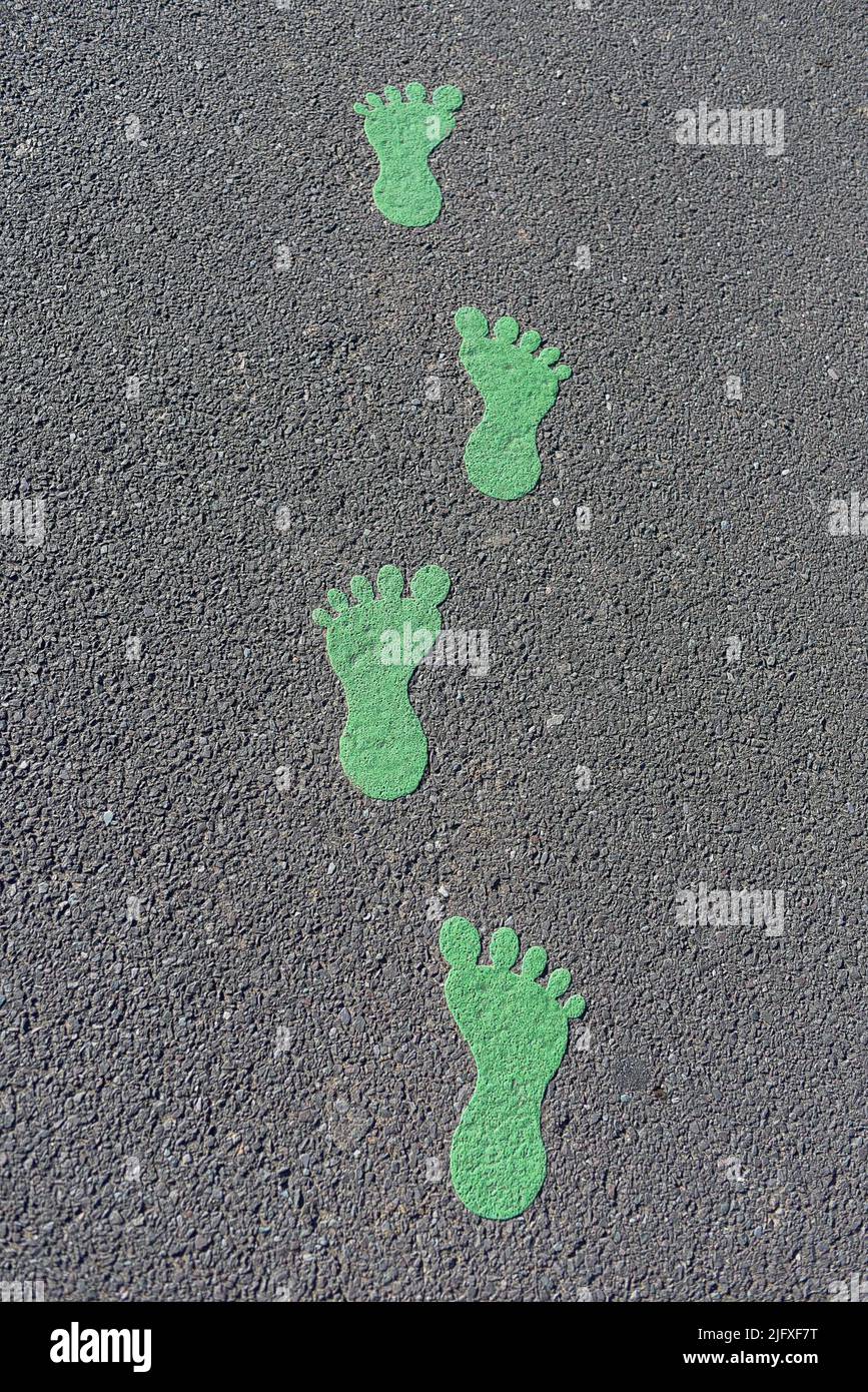 Green moulded footprints on playground Stock Photo