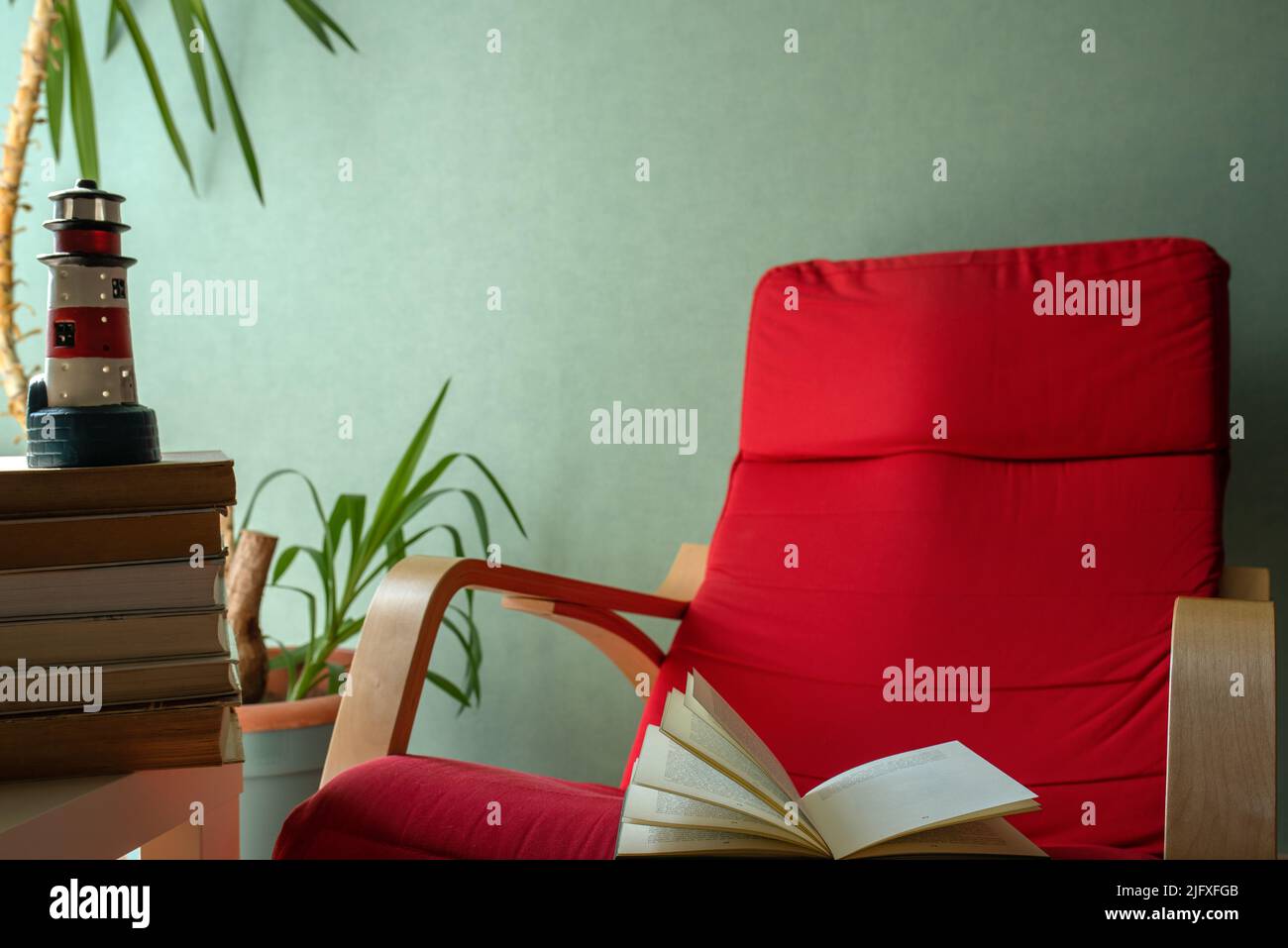 open book on a red armchair Stock Photo
