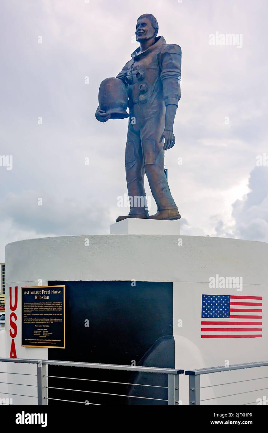 A statue of Apollo 13 astronaut Fred Haise faces the Biloxi Lighthouse, July 4, 2022, in Biloxi, Mississippi. Haise is a native of Biloxi. Stock Photo