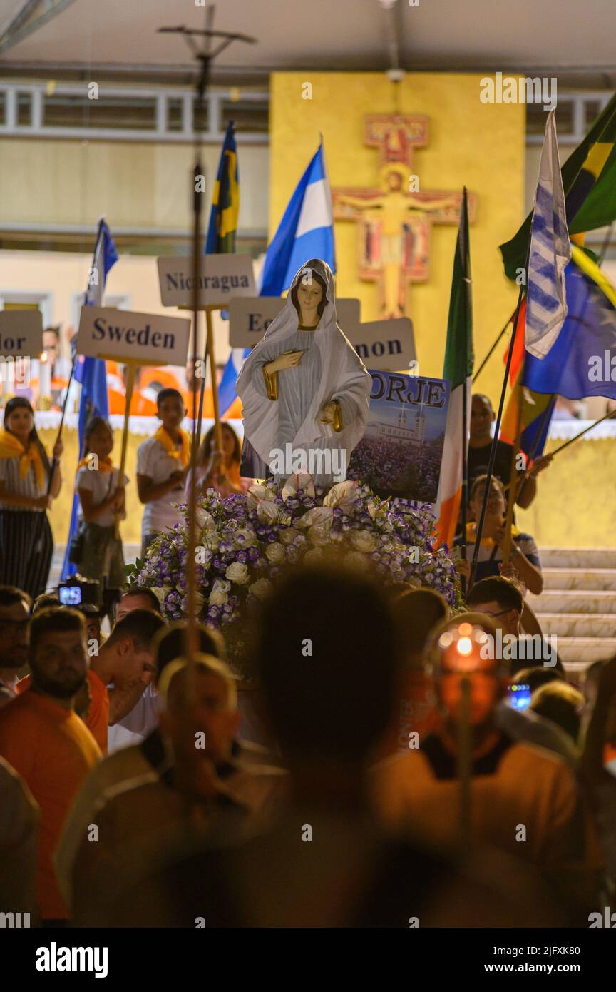 A procession with the statue of the Virgin Mary the Queen of Peace after the Holy Mass during Mladifest – the youth festival – in Medjugorje. Stock Photo