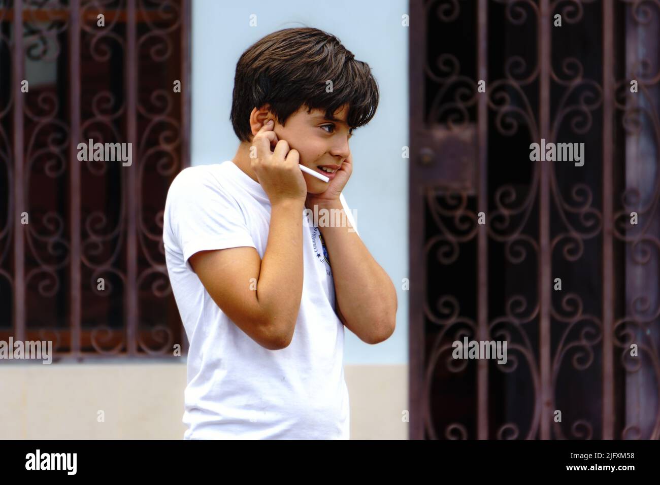 Nicaragua boy around 8-10 years old holds his ears as other not in the frame shoot off fireworks in Jinotega, Nicaragua. Stock Photo