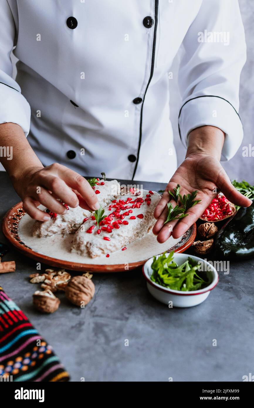 mexican woman chef cooking chiles en nogada recipe with Poblano chili ...